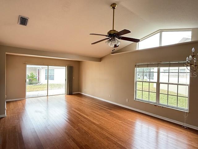 spare room featuring hardwood / wood-style floors, ceiling fan, and vaulted ceiling