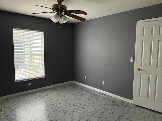 spare room with ceiling fan