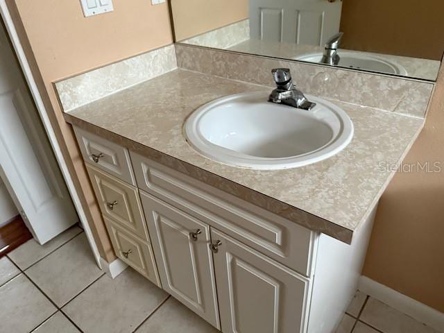 bathroom with tile patterned floors and vanity