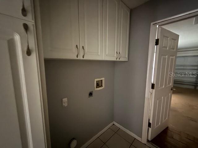 washroom featuring cabinets, hookup for a washing machine, tile patterned floors, and electric dryer hookup