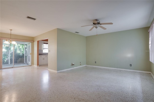 unfurnished room featuring ceiling fan with notable chandelier