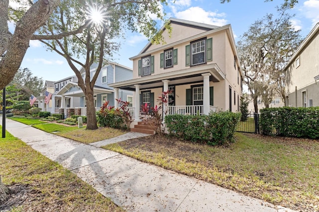 view of front of house with covered porch and a front yard