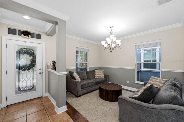 tiled foyer entrance with a notable chandelier, plenty of natural light, and crown molding