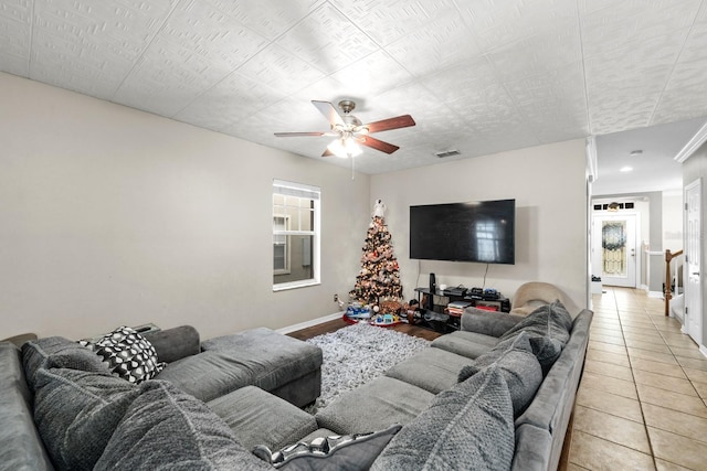 living room with tile patterned floors and ceiling fan