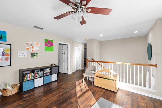 sitting room featuring ceiling fan and dark hardwood / wood-style flooring