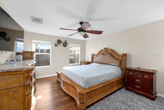 bedroom featuring dark hardwood / wood-style flooring and ceiling fan