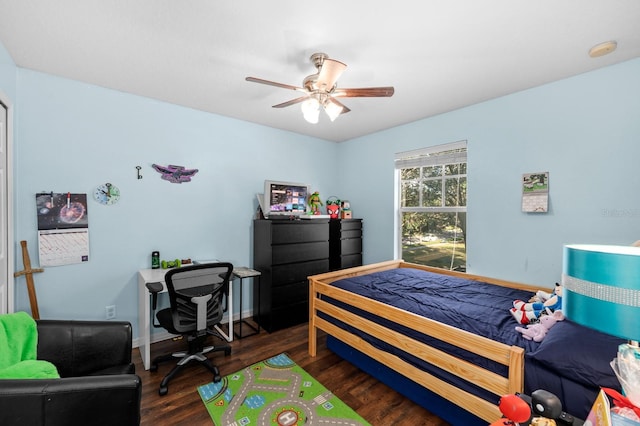 bedroom with ceiling fan and dark hardwood / wood-style flooring