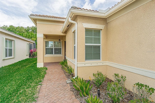 doorway to property with a lawn