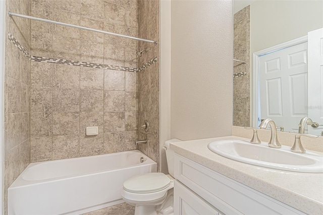 full bathroom with vanity, tile patterned floors, tiled shower / bath combo, and toilet