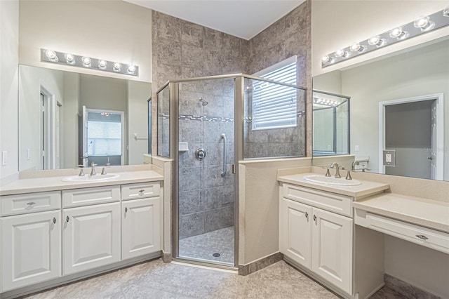 bathroom with vanity and a shower with shower door