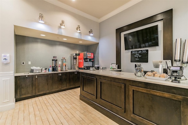 interior space with decorative backsplash, crown molding, and hardwood / wood-style floors