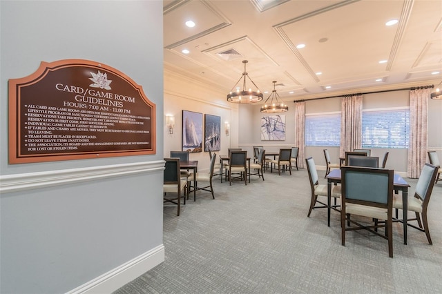 dining room featuring carpet flooring, ornamental molding, coffered ceiling, and an inviting chandelier