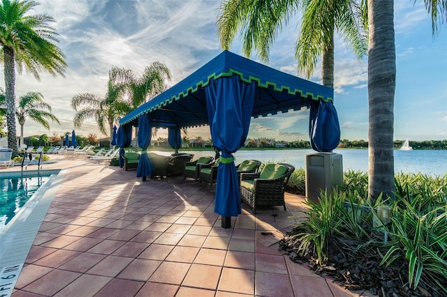 view of patio / terrace featuring a gazebo, a water view, and a community pool