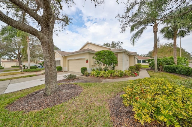 view of front of home with a front yard and a garage