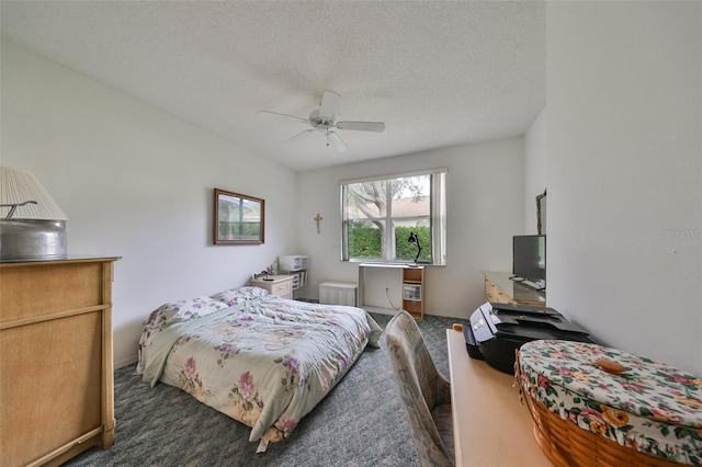 bedroom with a textured ceiling and ceiling fan