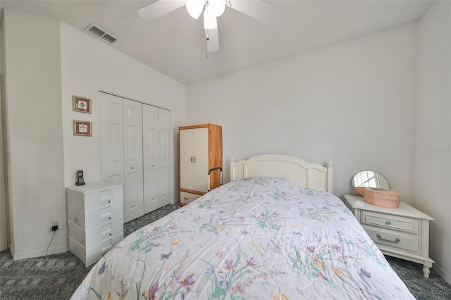 carpeted bedroom featuring ceiling fan and a closet