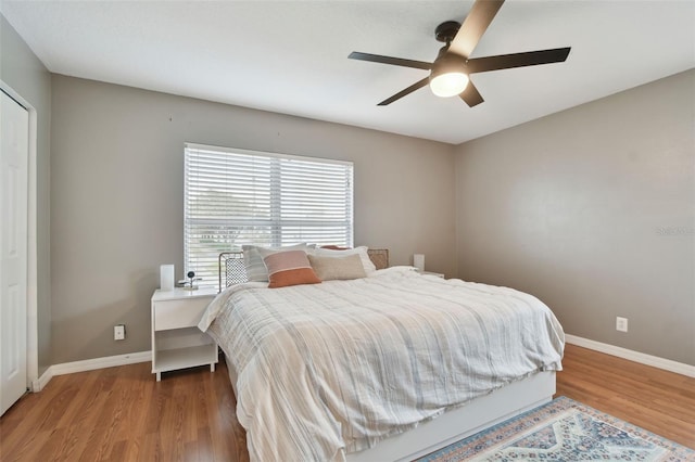 bedroom with ceiling fan and hardwood / wood-style floors