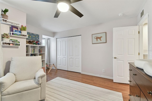 sitting room with ceiling fan and light hardwood / wood-style floors