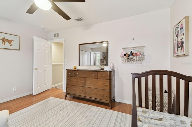 bedroom with ceiling fan and light hardwood / wood-style floors