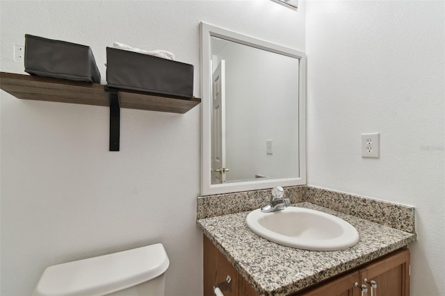 bathroom with toilet and vanity