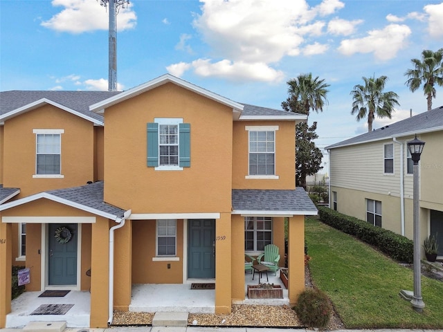 view of front property with a front lawn and a patio area