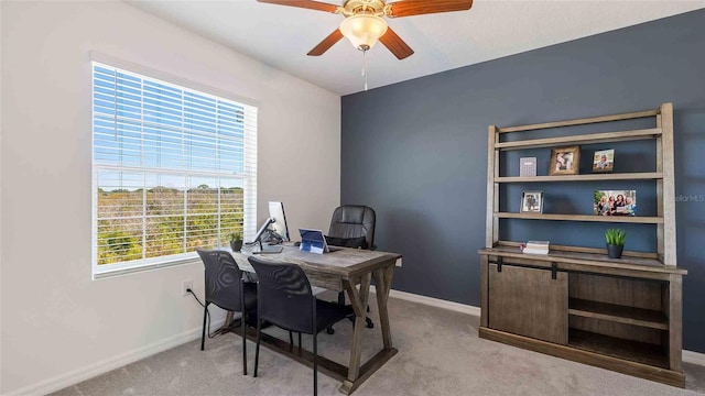 office area featuring ceiling fan and light colored carpet