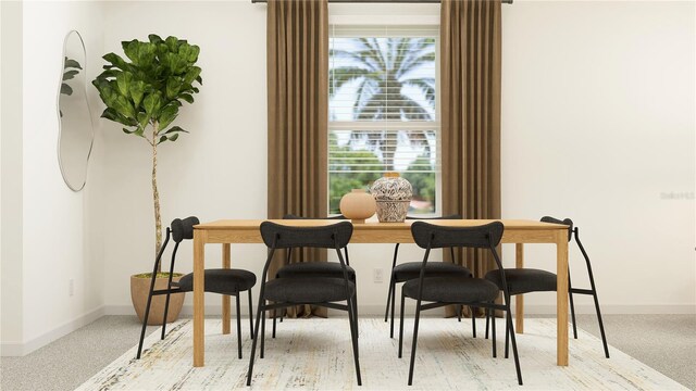 carpeted dining space featuring a healthy amount of sunlight