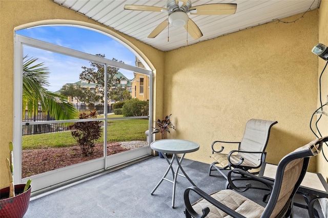 sunroom with ceiling fan and a healthy amount of sunlight