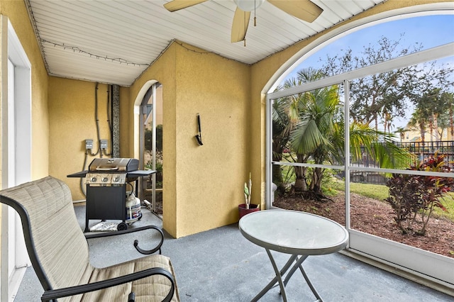 sunroom featuring ceiling fan