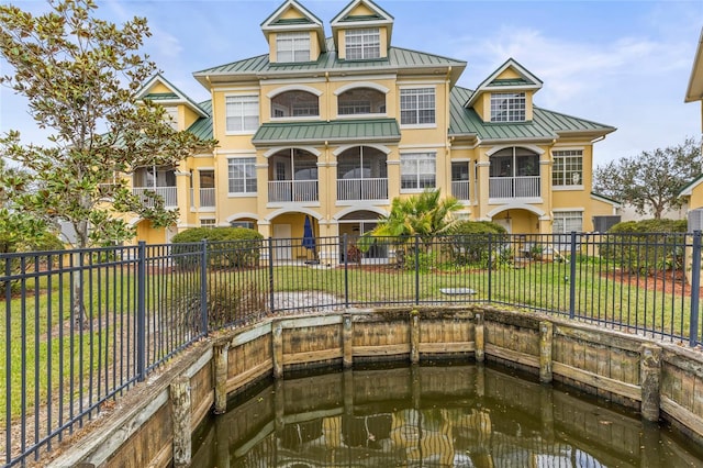 exterior space featuring a yard and a water view