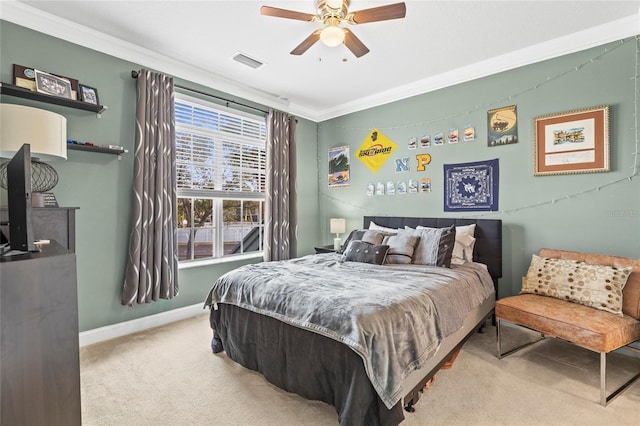 carpeted bedroom with ceiling fan and ornamental molding