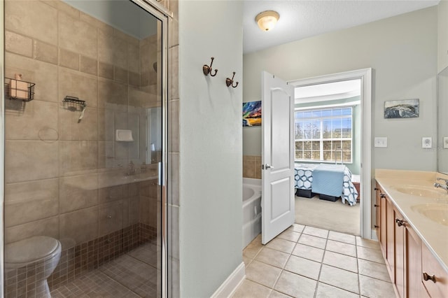 bathroom with tile patterned floors, vanity, and independent shower and bath