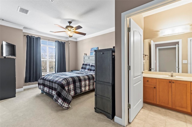 carpeted bedroom with connected bathroom, ceiling fan, ornamental molding, and sink