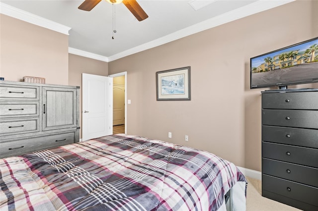 carpeted bedroom with ceiling fan and crown molding