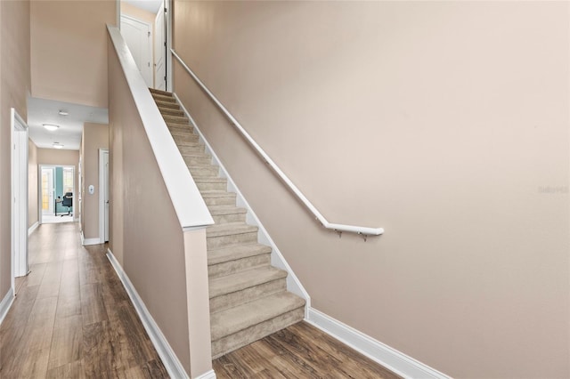 stairs with hardwood / wood-style flooring