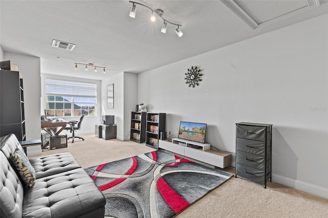 carpeted living room with a textured ceiling