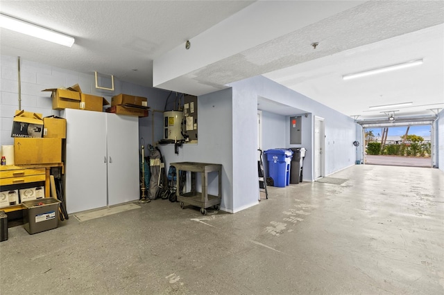 garage with electric panel and water heater