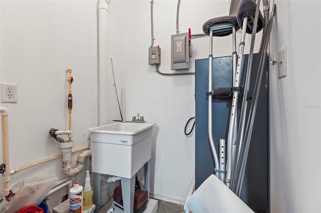 utility room with electric panel and sink