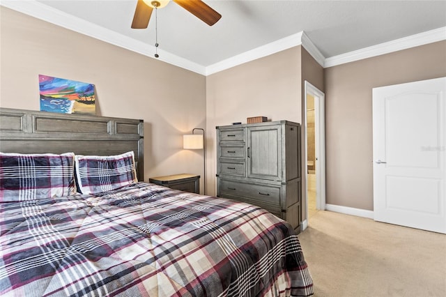 bedroom with ceiling fan, connected bathroom, light carpet, baseboards, and ornamental molding