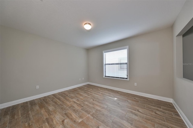 spare room featuring light wood-type flooring