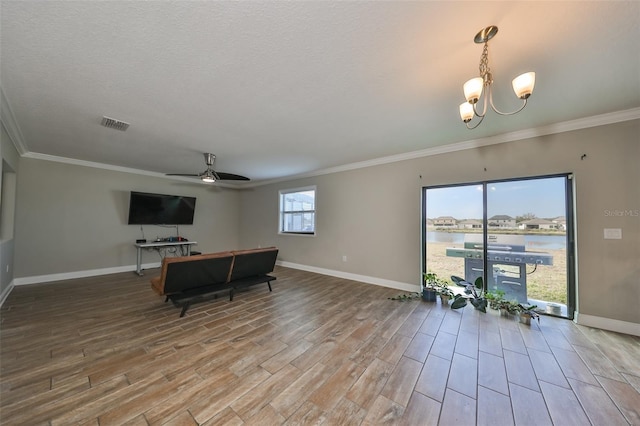 living room featuring a textured ceiling, wood-type flooring, ceiling fan with notable chandelier, and ornamental molding