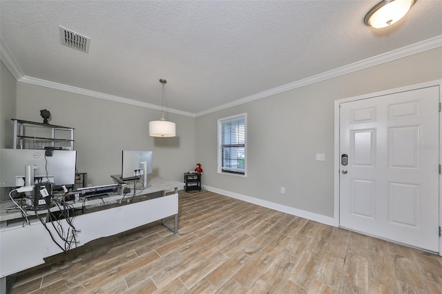 kitchen with pendant lighting, light hardwood / wood-style floors, ornamental molding, and a textured ceiling