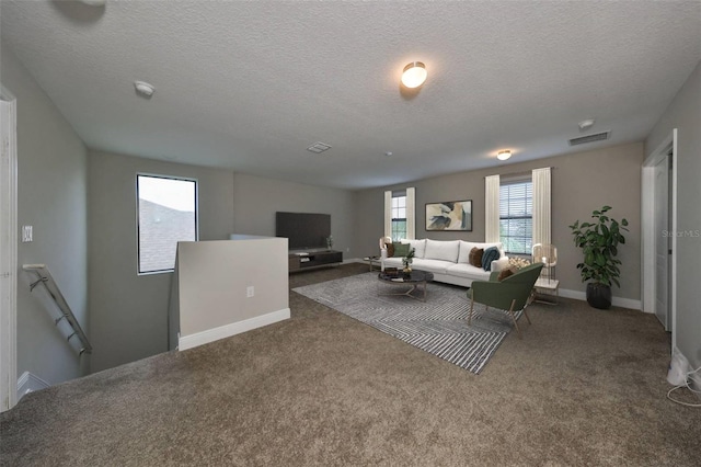 carpeted living room with a textured ceiling