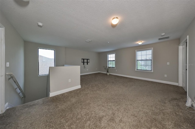 unfurnished room featuring carpet floors and a textured ceiling