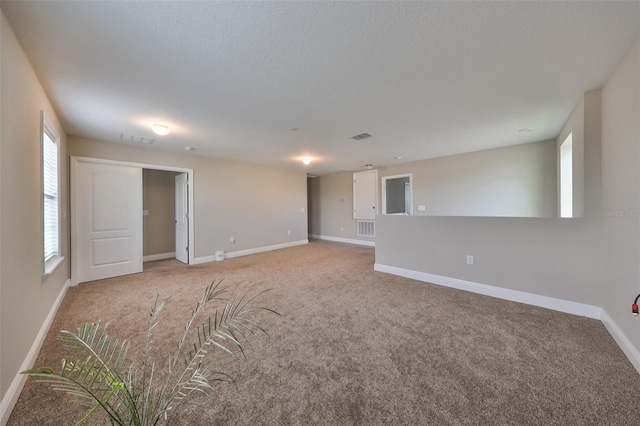 unfurnished room with light colored carpet