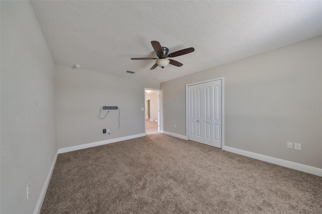 spare room with ceiling fan, carpet floors, and a textured ceiling