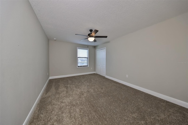 carpeted spare room with ceiling fan and a textured ceiling