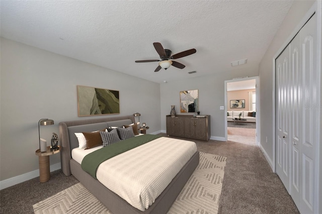 carpeted bedroom with a textured ceiling, a closet, and ceiling fan