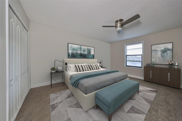 carpeted bedroom featuring ceiling fan, a textured ceiling, and a closet