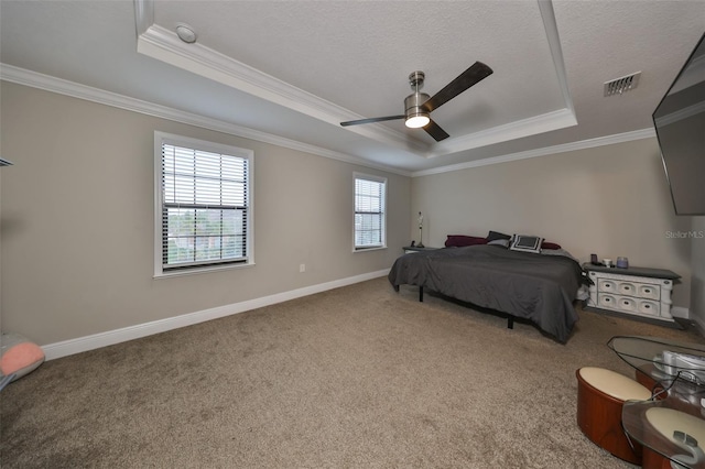 carpeted bedroom featuring ceiling fan, a raised ceiling, and crown molding